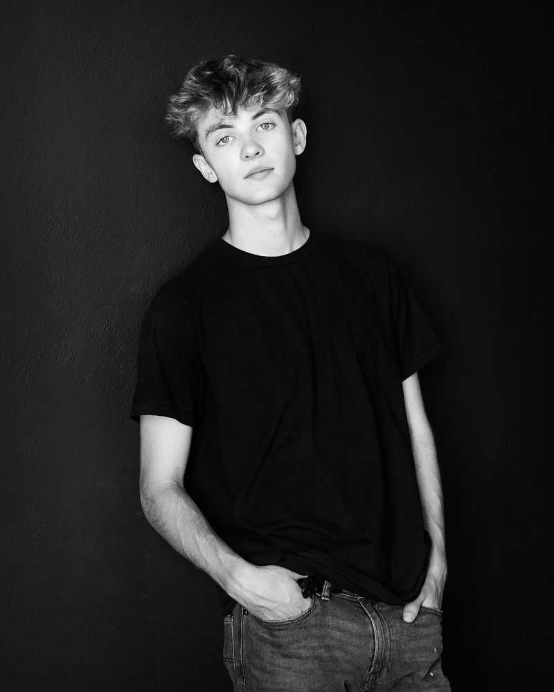 Black-and-white studio portrait of a senior in a T-shirt